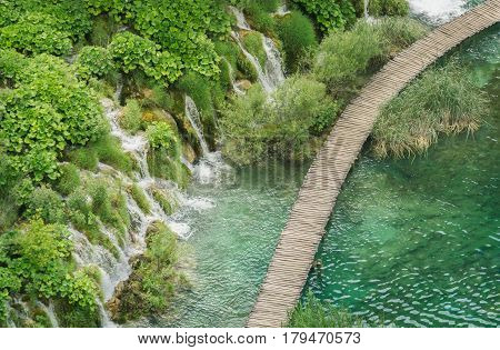 Aerial view overlooking a timber walkway and waterfalls in the beautiful Plitvice Lakes National Park in Croatia.