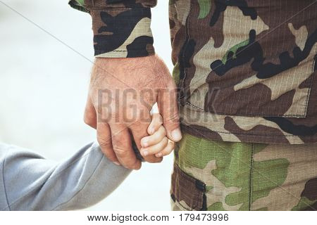 Two Hands  Of One Family - Father And Child Together. The Concept Of Family Unity Protection Support