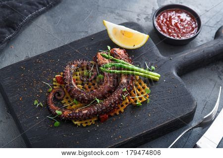 Grilled octopus with lemon asparagus and potatoes.