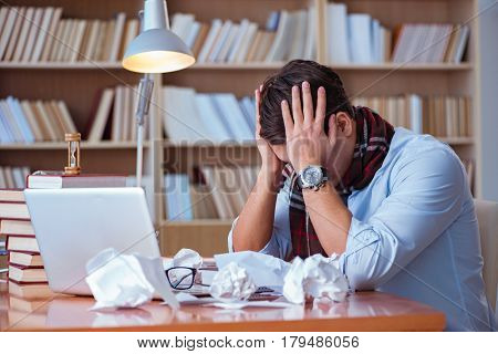 Young book writer writing in library