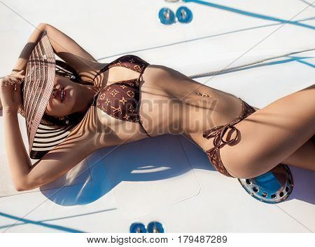 Young sexy woman on her private yacht