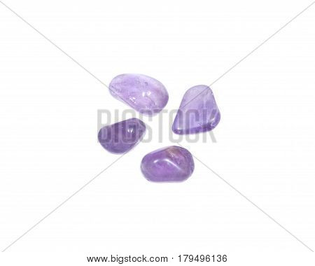 Tumbled amethyst stones from Brazil isolated on white background
