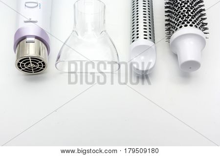 Collection electric hair dryer and hair curler in beauty salon isolate on white background Top view with copy space and text.