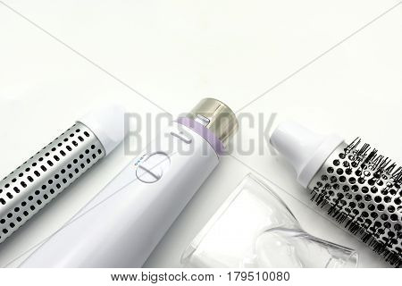 Collection electric hair dryer and hair curler in beauty salon isolate on white background Top view with copy space and text.