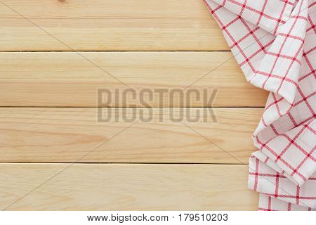 Tablecloth textile checkered picnic napkin on wooden table background Top view with blank space and text.