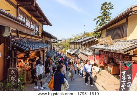 KYOTO JAPAN - APRIL 19 2015: Tourists walk on a street around Kiyomizu Temple. Kiyomizu is a famous temple in Kyoto built in year 778. That is part of the Historic Monuments of Ancient Kyoto Japan