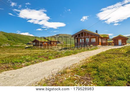 Mountan cabin houses with grass roof melding with the landscape and surrounding environment. Lofoten Islands, Norway.