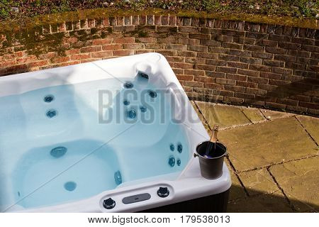 bottle of champagne cooling by hot tub 