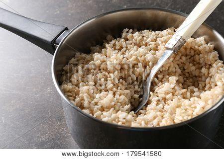 Stewpot full of brown rice saturated with water