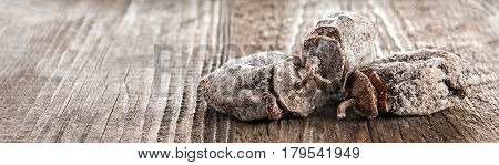 Dried persimmon fruits on wooden background. Oriental sweets