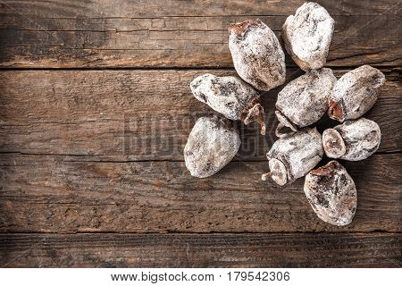 Dried persimmon fruits on wooden background. Oriental sweets