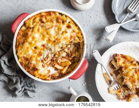 Turkish macaroni and cheese with minced beef on a gray background top view. Delicious lunch