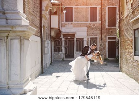 Bride and groom dancing in Venice in wedding day Venezia Italy