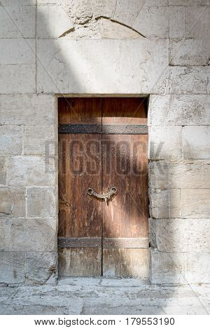Wooden aged door and stone wall at Bebars Mosque Medieval Cairo Egypt
