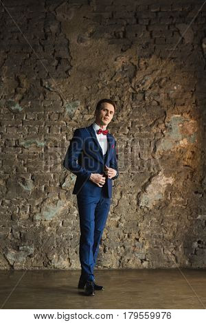 young businessman in blue suit emotional posing