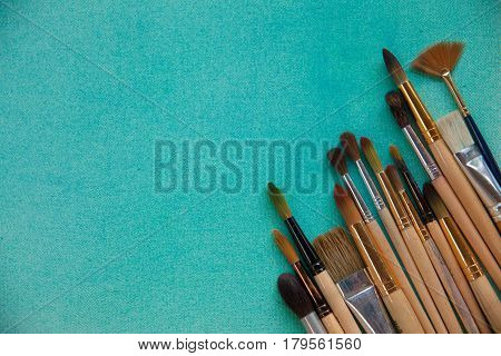 Lots Of Paintbrushes On Colorful Canvas Background