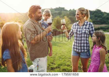 Winemaker family happy together in vineyard before harvesting