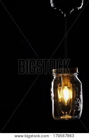 Vintage rustic design style bulb in jar pendant lights on black background.Copyspace