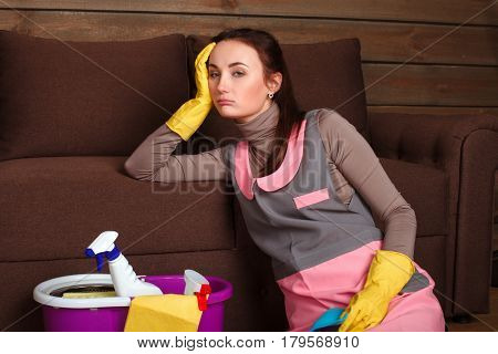 Female cleaning servisce worker asleep on a couch