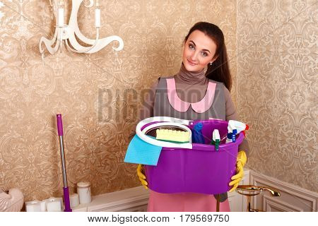 Woman holding cleaning supplies in hands