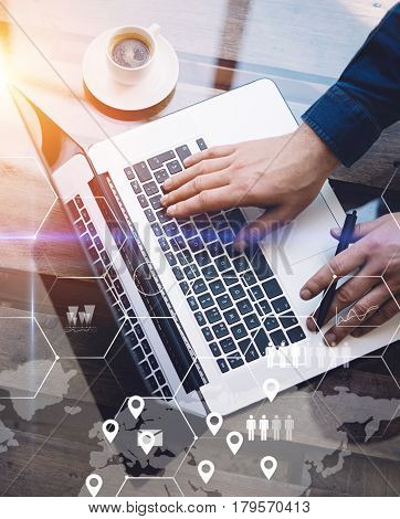 Concept of digital screen, virtual connection icon, diagram, graph interfaces.Man working with laptop at office at wooden table.Reflections on glass surface.Flares effect.Vertical