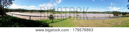 GOLD COAST, QUEENSLAND, AUSTRALIA - MARCH 31ST: Flood waters Panorama at the Coomera River Weir on 31st March at Oxenford.