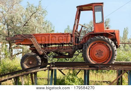 Old red truck abandoned in the trestlework