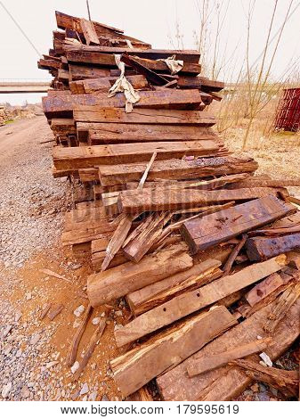 Terrible Smell Pile Of Extracted Old Wooden Ties. Old Oiled Used Oak Railway Sleepers Stored