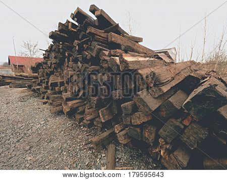 Extracted Old Wooden Ties In Stock. Old Oiled Used Oak Railway Sleepers Stored After Reconstruction