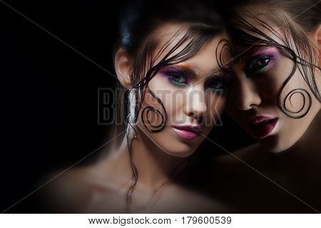 Mysterious portrait with reflection. Alter-ego. Girl with bright makeup and wet hair