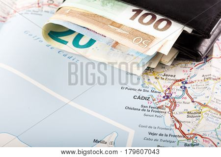 European union currency in a wallet on a map background. Travel concept.
