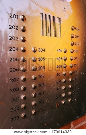 Old weathered intercom button panel selective focus