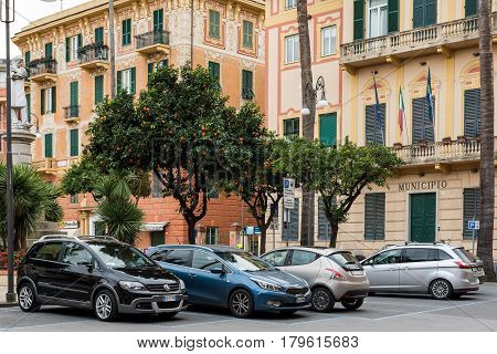 SANTA MARGHERITA LIGURE, ITALY - DECEMBER 2016: Parked cars under citrus trees in Santa Margherita Ligure, Italy