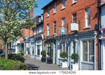 Hartley Wintney, UK. 2nd April 2017. Springtime on a Sunday afternoon in Hartley Wintney high street. Shops and retail establishments are open.