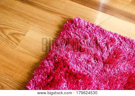 Pink Purple Rug On Wooden Floor Cropped Detail