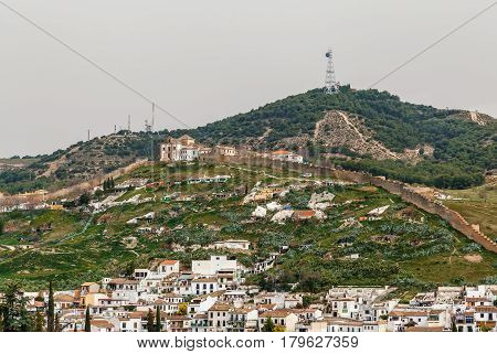 View of Ermita de San Miguel Alto with wall from Alhambra Granada Spain