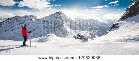 Man Skiing On The Prepared Slope With Fresh New Powder Snow In Alps