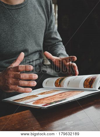 A man in a Georgian restaurant is ordering food, Khachapuri is a national dish of Georgia