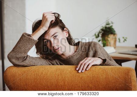 indoor portrait of beautiful feminine thoughtful young women alone in the room.