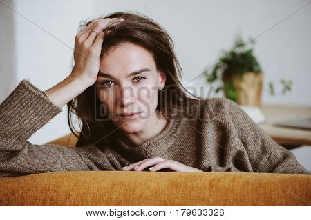 indoor portrait of beautiful feminine thoughtful young women alone in the room.