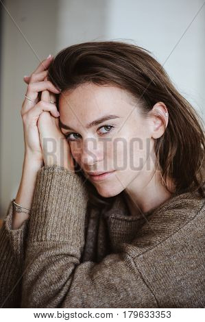indoor portrait of beautiful feminine thoughtful young women alone in the room.