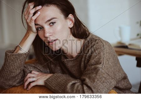 indoor portrait of beautiful feminine thoughtful young women alone in the room.