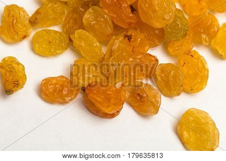 Macro photo of organic dried golden raisins on white background