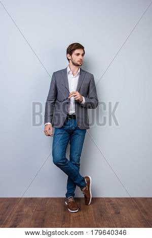 Handsome Young Man With Bristle In Casual Clothes Holding Spectacles And Posing. Successful Stylish