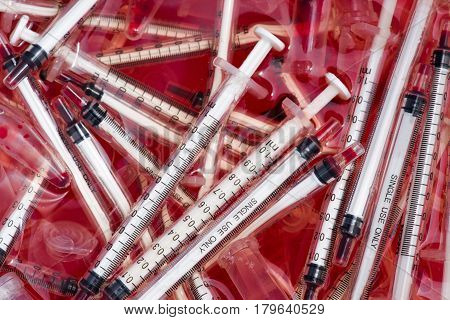 Infectious waste be disposed of bloody injections in the red trash.
