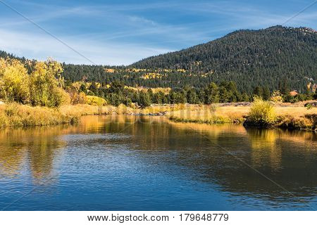 Autumn landscape of river and bright trees