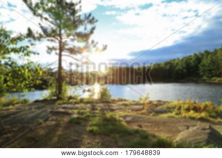 View summer on the river with sun rays through the tree in blurred for background