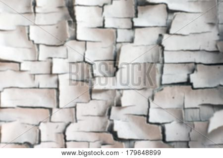 The old paint in the cracks on the wall in blurred for background