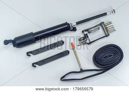 Mini bike pump with presta & schrader valve compatibles,multifunction bicycle mechanic fix tools set tools allen keys,inner tube & tire patch levers on white background
