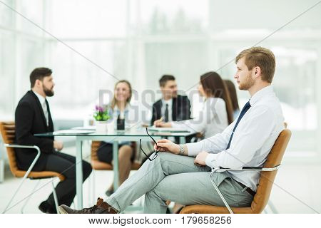 lawyer of the company on the background of the working meeting the business team.the photo has a empty space for your text